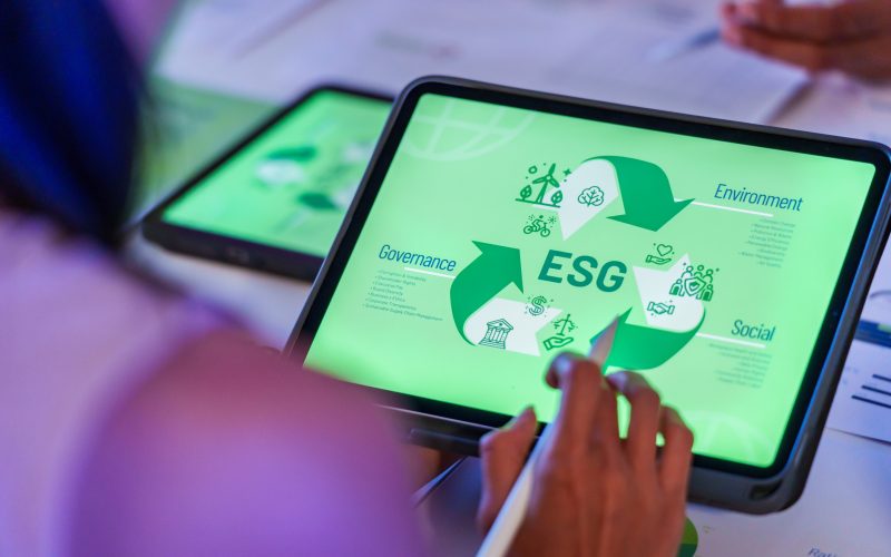 ESG ( environment, social,governance) recycle sign on laptop screen with carbon free chart board in office ESG ( environment, social,governance) recycle sign on laptop screen with carbon free chart board in office